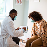 Photo of a Doctor reviewing test results with a patient